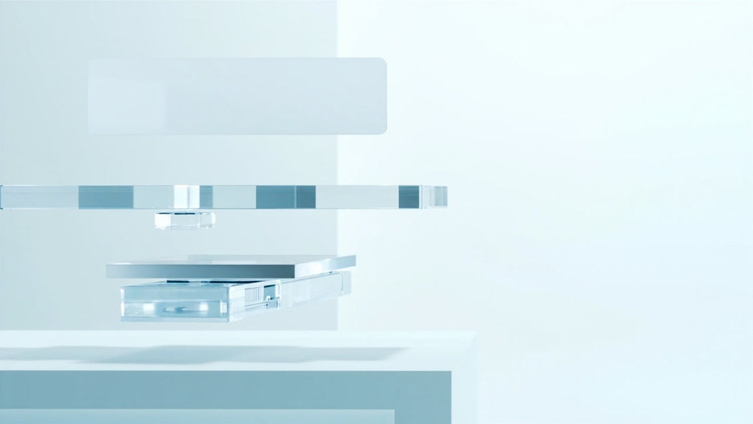 minimal digital workspace with translucent devices glowing in soft blue and silver light