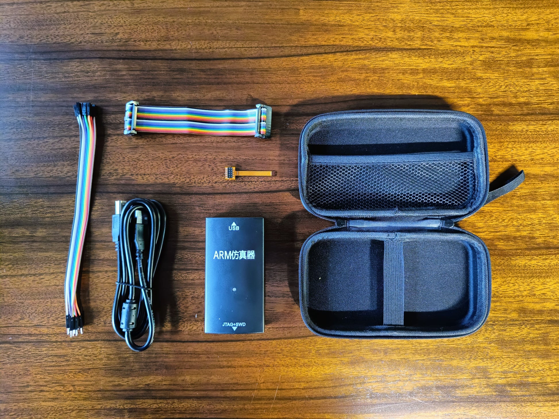 Collection of electronic components and accessories on a wooden surface